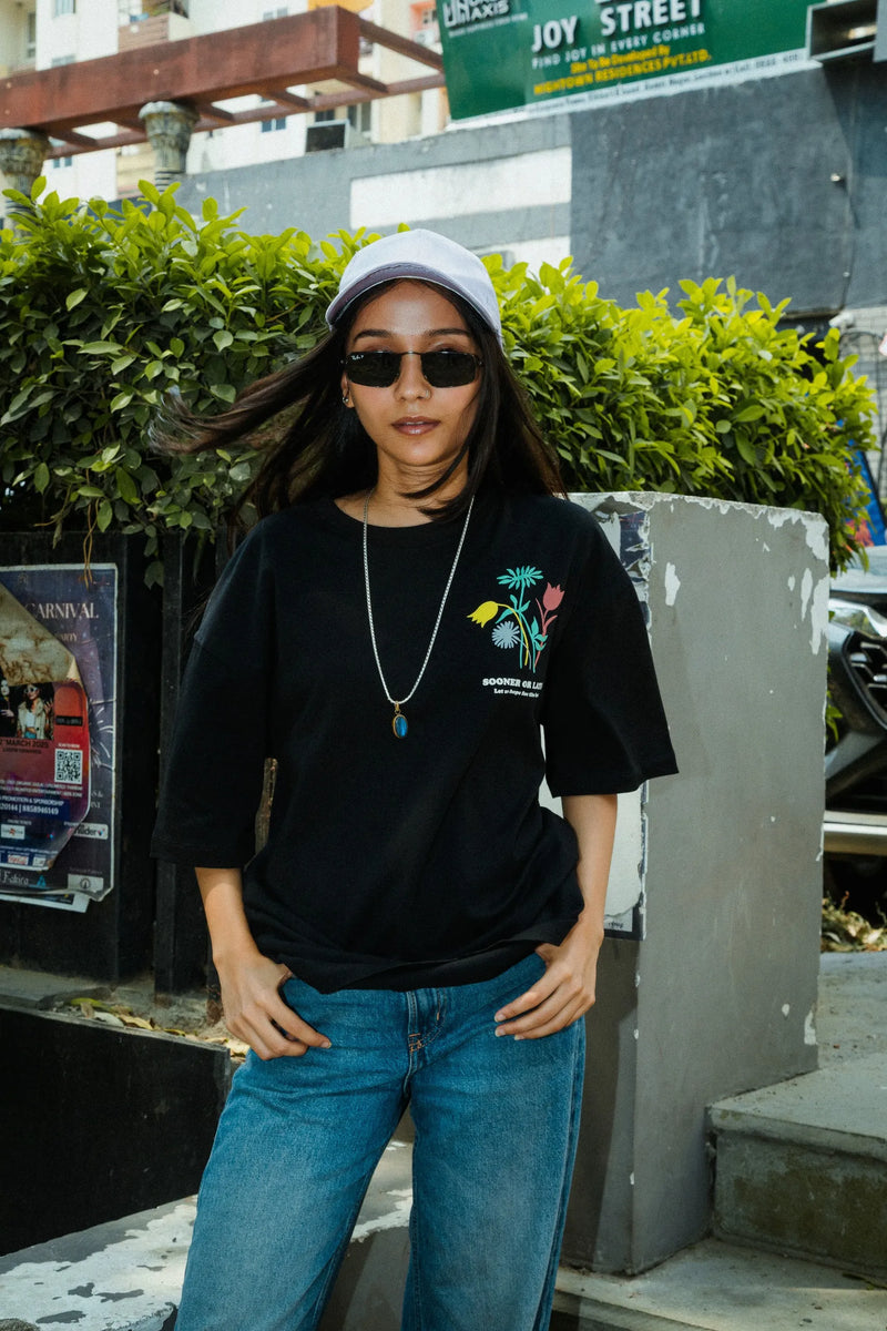 Women Oversized Black T-Shirt with “Time Will Tell” & Floral Graphic Print